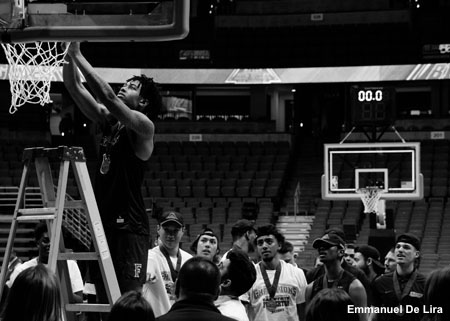 Basketball player taking down net